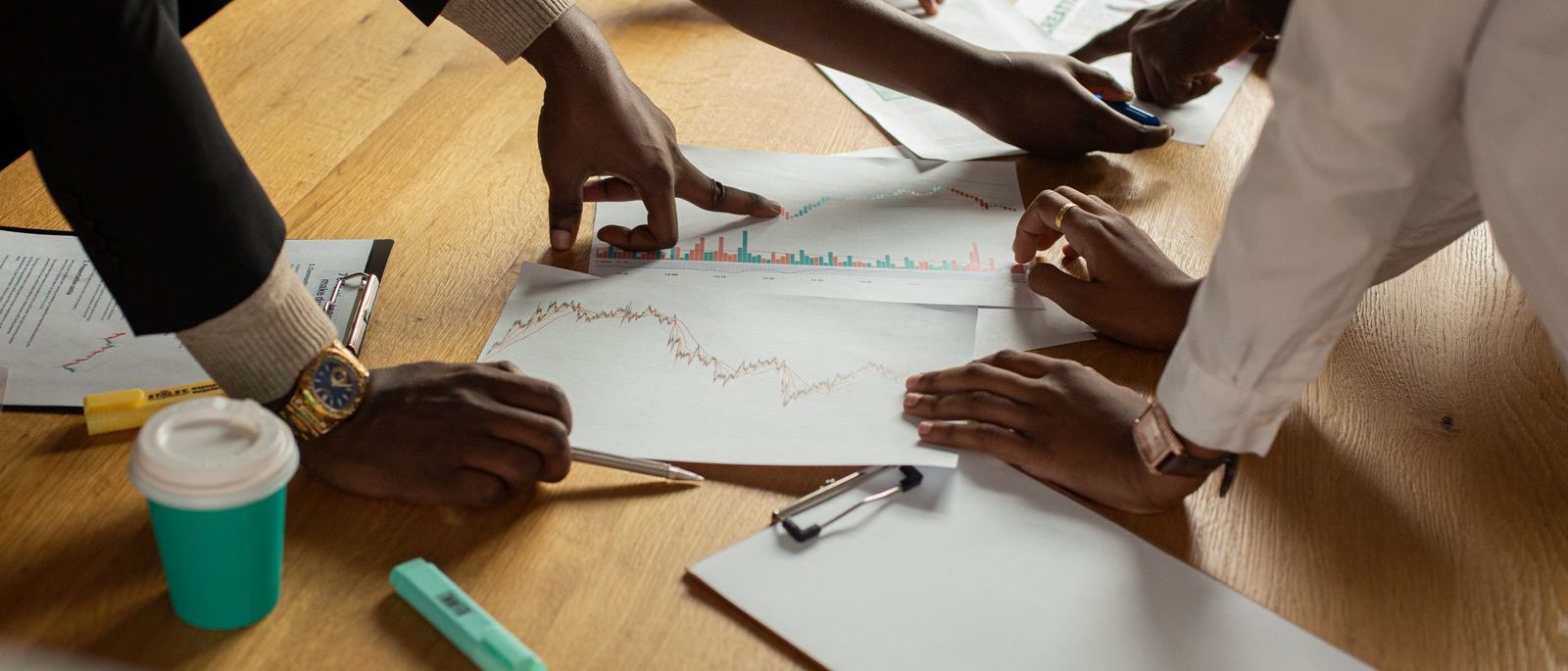 Researchers reviewing charts and printed data together